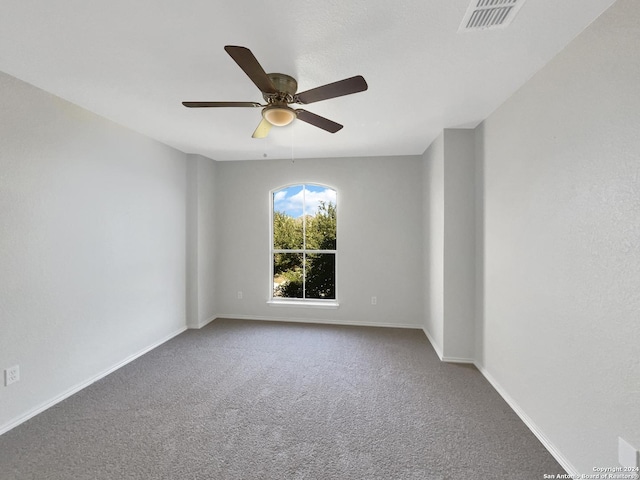 empty room featuring carpet floors and ceiling fan