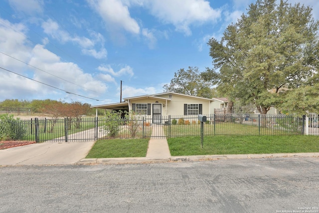 view of front of home with a front yard and a carport