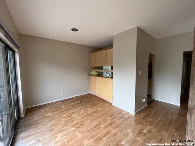 kitchen featuring light brown cabinetry and light hardwood / wood-style floors