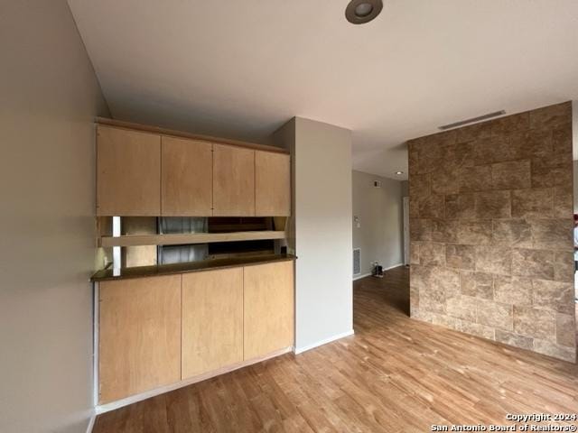 kitchen featuring light brown cabinetry and light hardwood / wood-style flooring