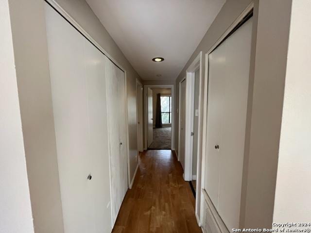 hall with dark hardwood / wood-style floors