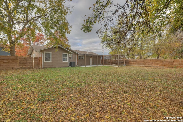 view of yard featuring central AC and a patio