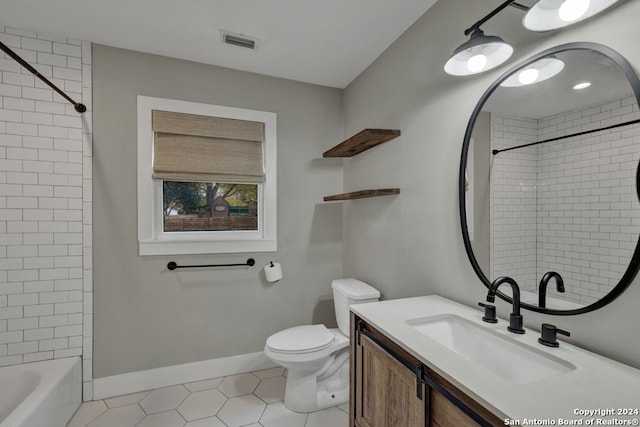 full bathroom featuring tile patterned flooring, vanity, toilet, and tiled shower / bath combo