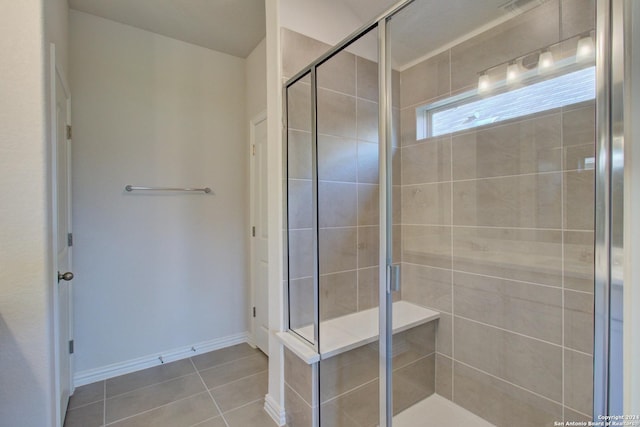 bathroom featuring tile patterned flooring and an enclosed shower