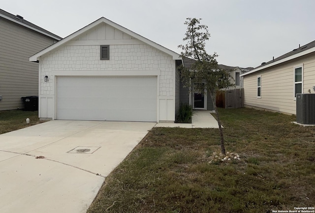 ranch-style home with a garage, central air condition unit, and a front lawn