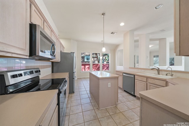 kitchen with a center island, light brown cabinets, sink, decorative light fixtures, and stainless steel appliances