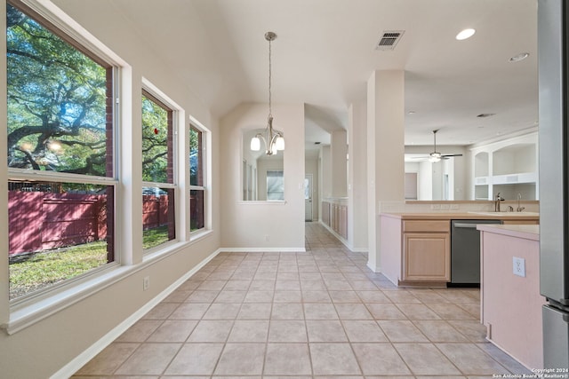 kitchen with pendant lighting, dishwasher, ceiling fan with notable chandelier, light tile patterned floors, and plenty of natural light