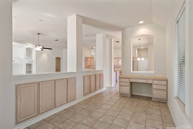 bathroom with tile patterned flooring, ceiling fan with notable chandelier, and built in features