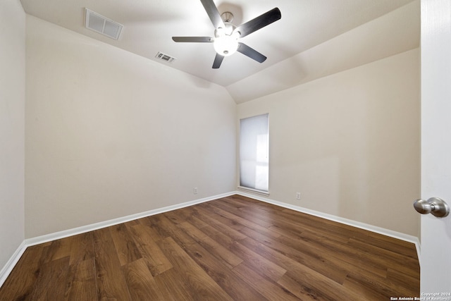 spare room with ceiling fan, wood-type flooring, and vaulted ceiling