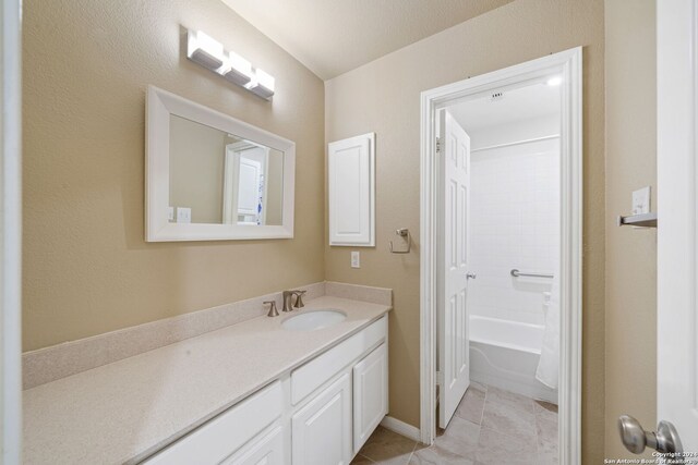 bathroom featuring tile patterned floors, vanity, and shower / tub combo