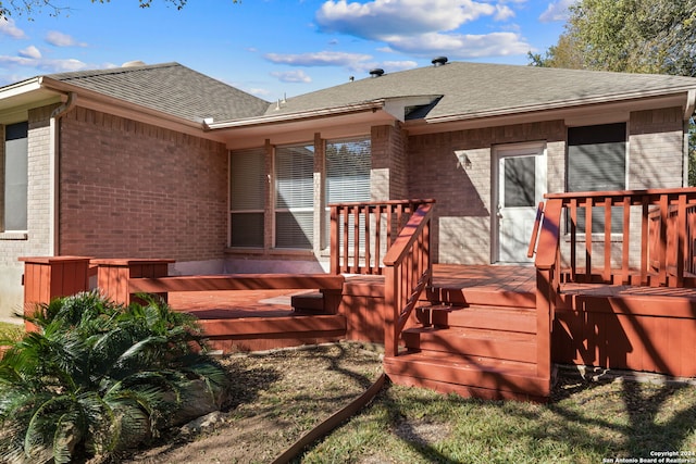 back of property featuring a wooden deck