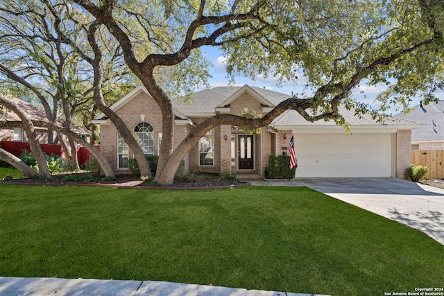 view of front of home with a front yard and a garage