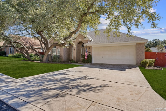 single story home featuring a garage and a front lawn