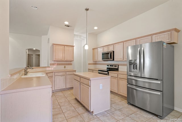 kitchen with kitchen peninsula, sink, light brown cabinets, and appliances with stainless steel finishes