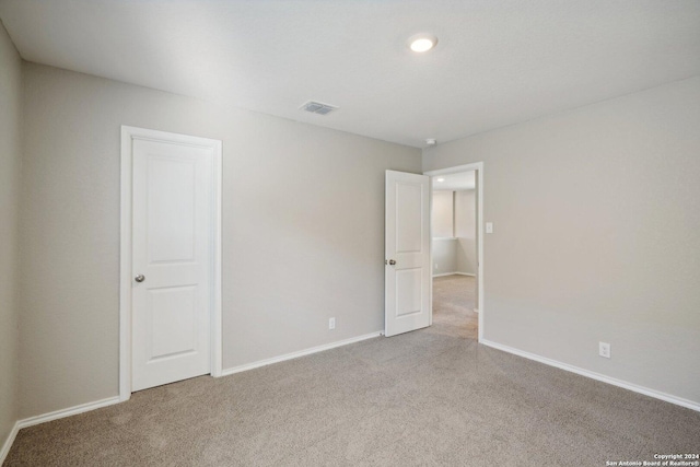 empty room with light colored carpet