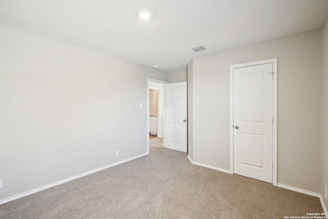 unfurnished bedroom featuring light carpet