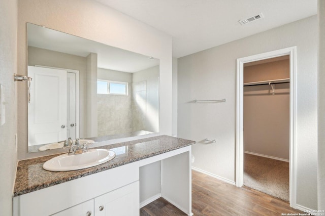 bathroom with hardwood / wood-style flooring, vanity, and toilet