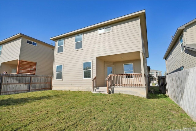 rear view of house with a yard