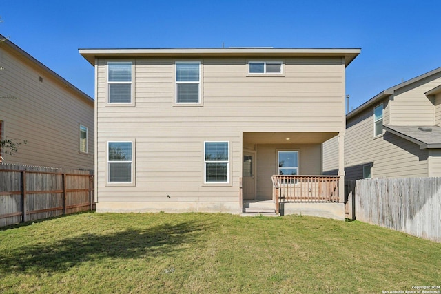 back of house featuring a yard