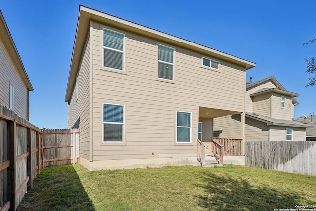 back of house featuring a yard