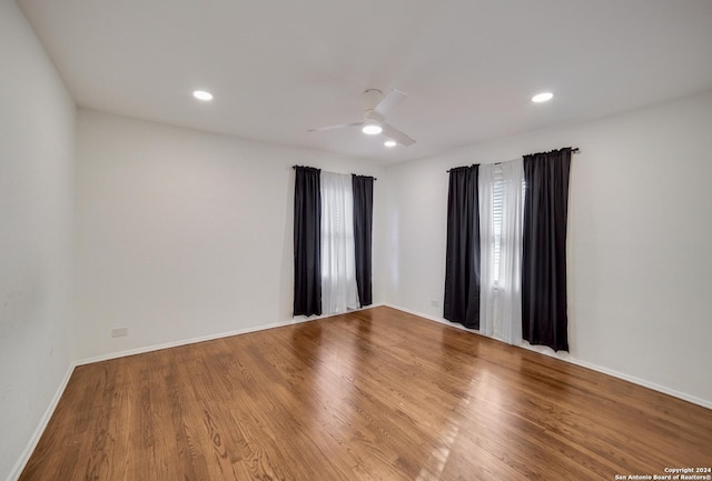 spare room with hardwood / wood-style flooring and ceiling fan