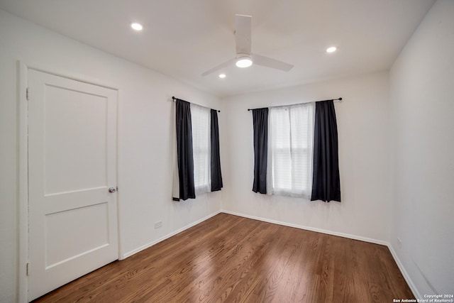 unfurnished room with ceiling fan and wood-type flooring