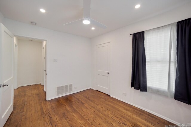 unfurnished room with ceiling fan and wood-type flooring