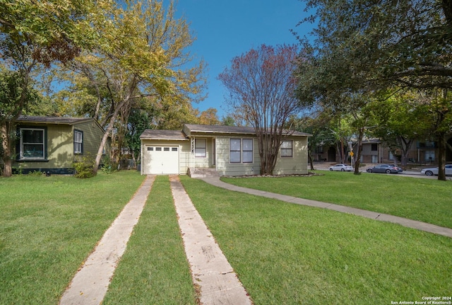 ranch-style house featuring a garage and a front lawn