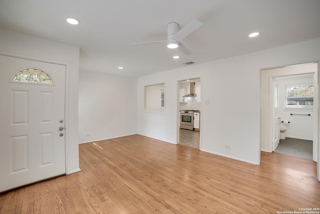 foyer featuring ceiling fan and light wood-type flooring