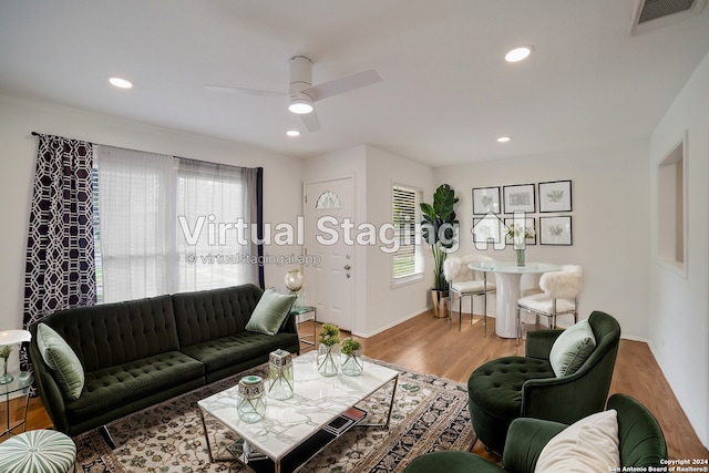 living room featuring ceiling fan and light hardwood / wood-style floors