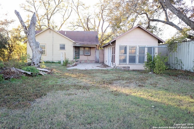 back of property with a lawn