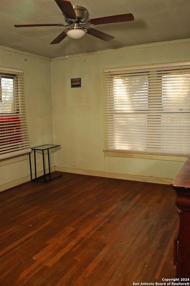 empty room featuring dark hardwood / wood-style flooring and ceiling fan