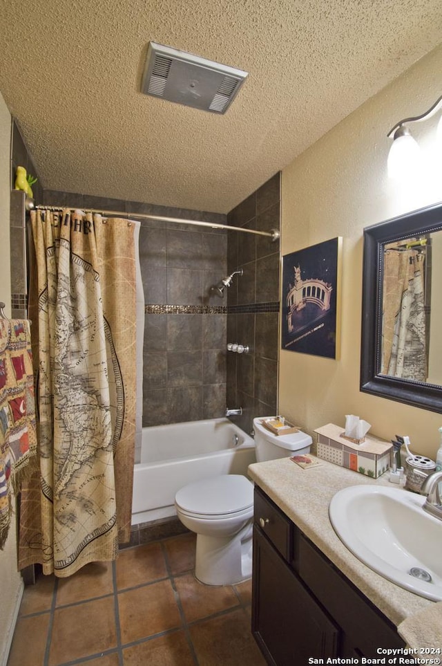 full bathroom featuring shower / bath combo, vanity, a textured ceiling, tile patterned flooring, and toilet