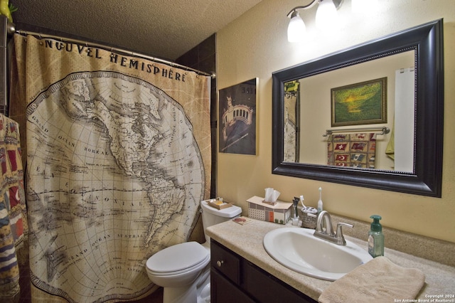 bathroom with vanity, a textured ceiling, toilet, and walk in shower