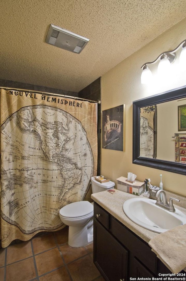 bathroom featuring curtained shower, tile patterned flooring, a textured ceiling, toilet, and vanity