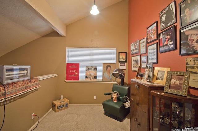 miscellaneous room with carpet flooring and vaulted ceiling with beams