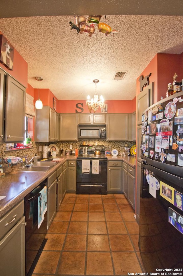 kitchen featuring sink, an inviting chandelier, tasteful backsplash, decorative light fixtures, and black appliances