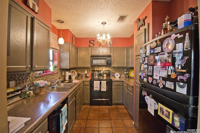 kitchen with sink, an inviting chandelier, backsplash, pendant lighting, and black appliances