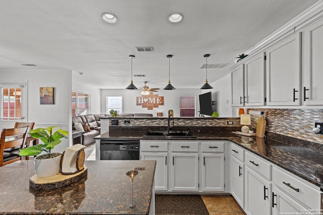 kitchen featuring a wealth of natural light and dark stone countertops