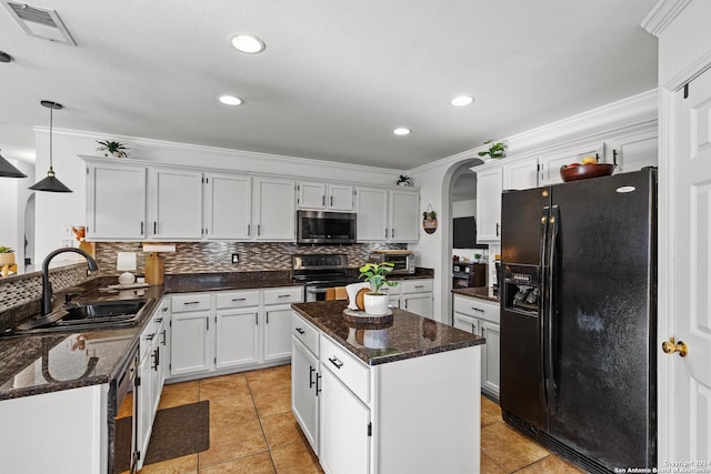 kitchen featuring white cabinetry, sink, decorative light fixtures, and appliances with stainless steel finishes