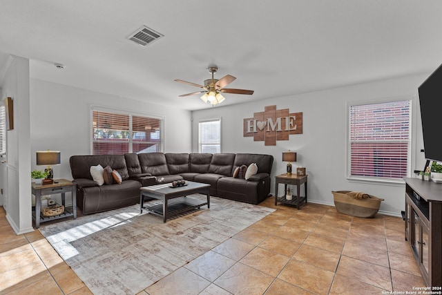 living room featuring ceiling fan and light tile patterned floors