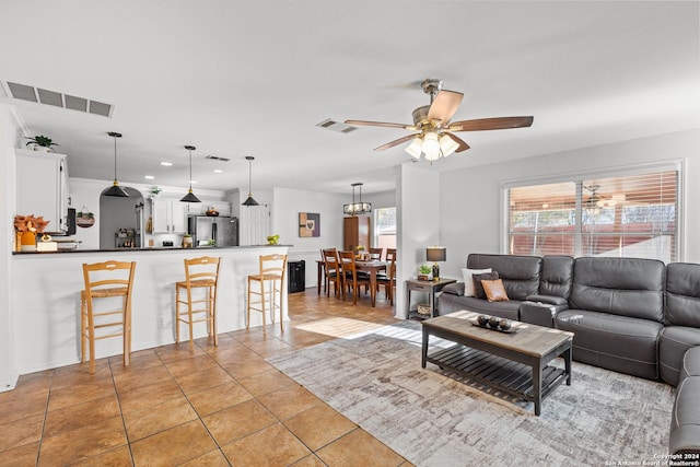 tiled living room with ceiling fan