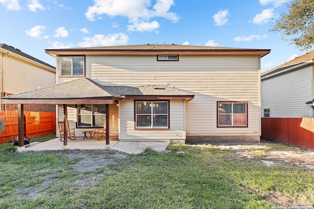 rear view of property featuring a yard and a patio