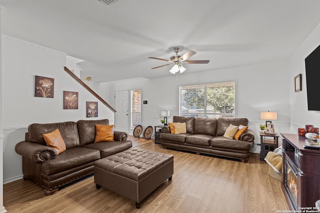 living room featuring ceiling fan and light hardwood / wood-style flooring