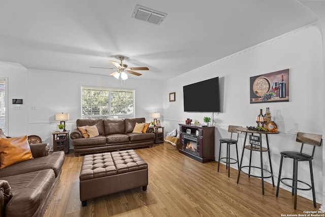 living room with ceiling fan and light hardwood / wood-style floors