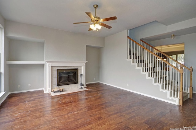 unfurnished living room with ceiling fan, dark hardwood / wood-style flooring, and a fireplace