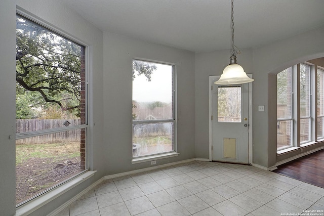 unfurnished dining area with light tile patterned floors