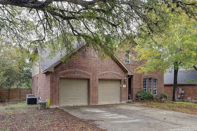 view of front of house with a garage and central AC unit