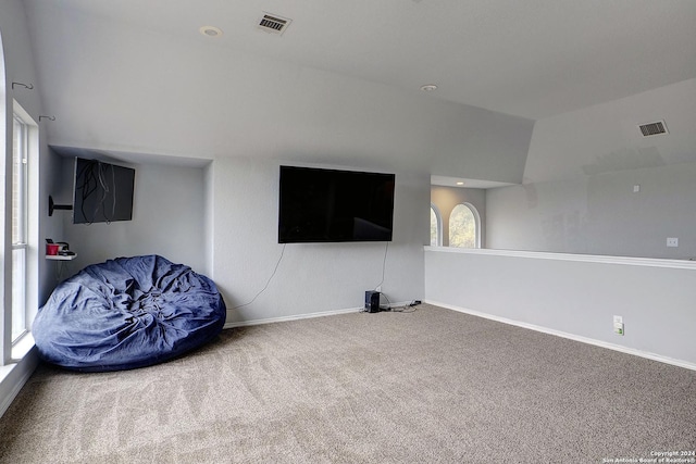 unfurnished room featuring carpet floors and lofted ceiling