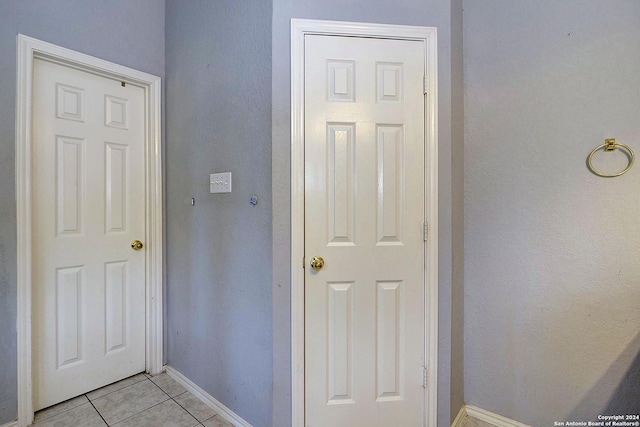 hall with light tile patterned flooring